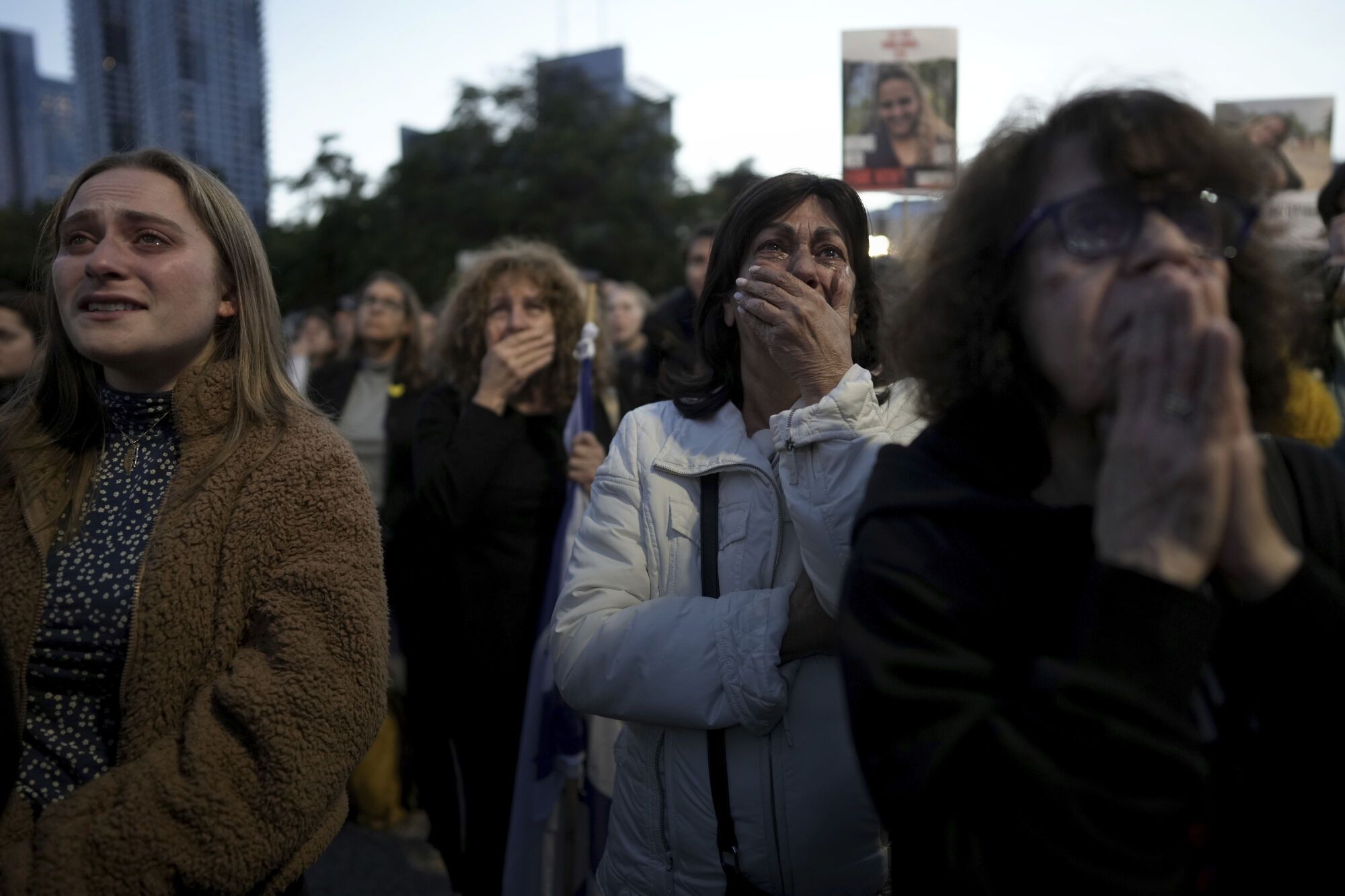 Relatives and friends of people killed and abducted by Hamas and taken into Gaza, react as they gather in Tel Aviv, Israel on Sunday, Jan. 19, 2025. (AP Photo/Oded Balilty). EDITORIAL USE ONLY / ONLY ITALY AND SPAIN