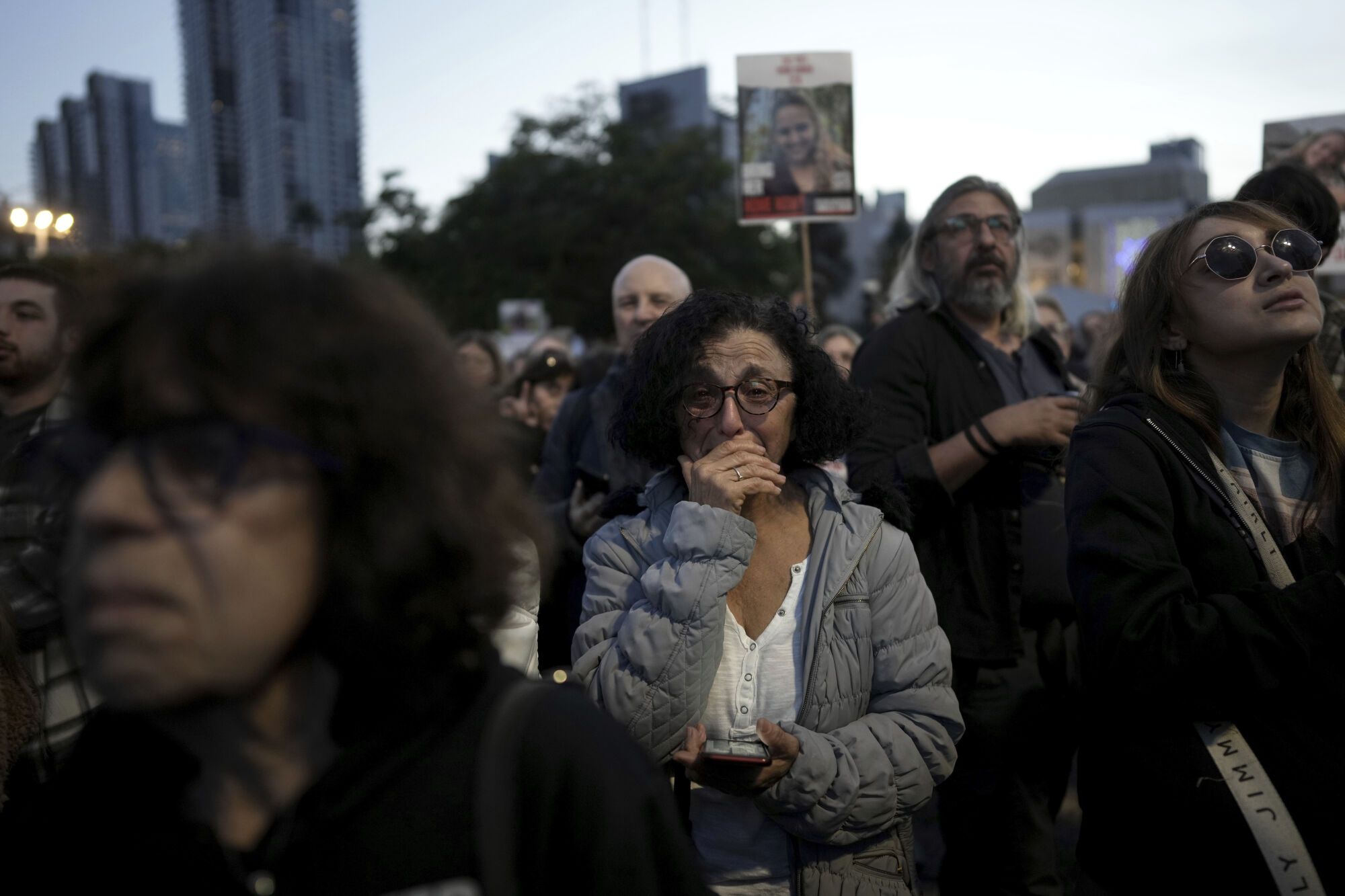 Relatives and friends of people killed and abducted by Hamas and taken into Gaza, react as they gather in Tel Aviv, Israel on Sunday, Jan. 19, 2025. (AP Photo/Oded Balilty). EDITORIAL USE ONLY / ONLY ITALY AND SPAIN