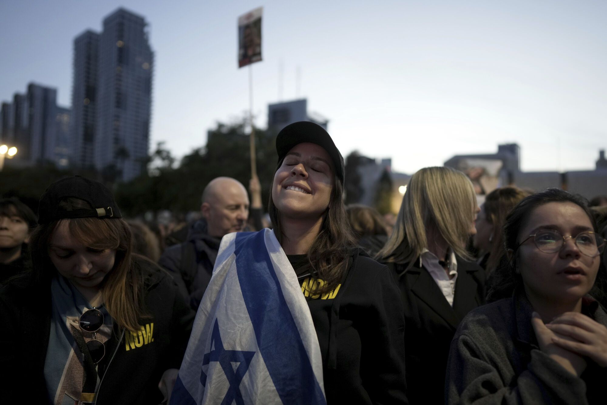 Relatives and friends of people killed and abducted by Hamas and taken into Gaza, react to the news of the hostages' release, as they gather in Tel Aviv, Israel on Sunday, Jan. 19, 2025. (AP Photo/Oded Balilty). EDITORIAL USE ONLY / ONLY ITALY AND SPAIN