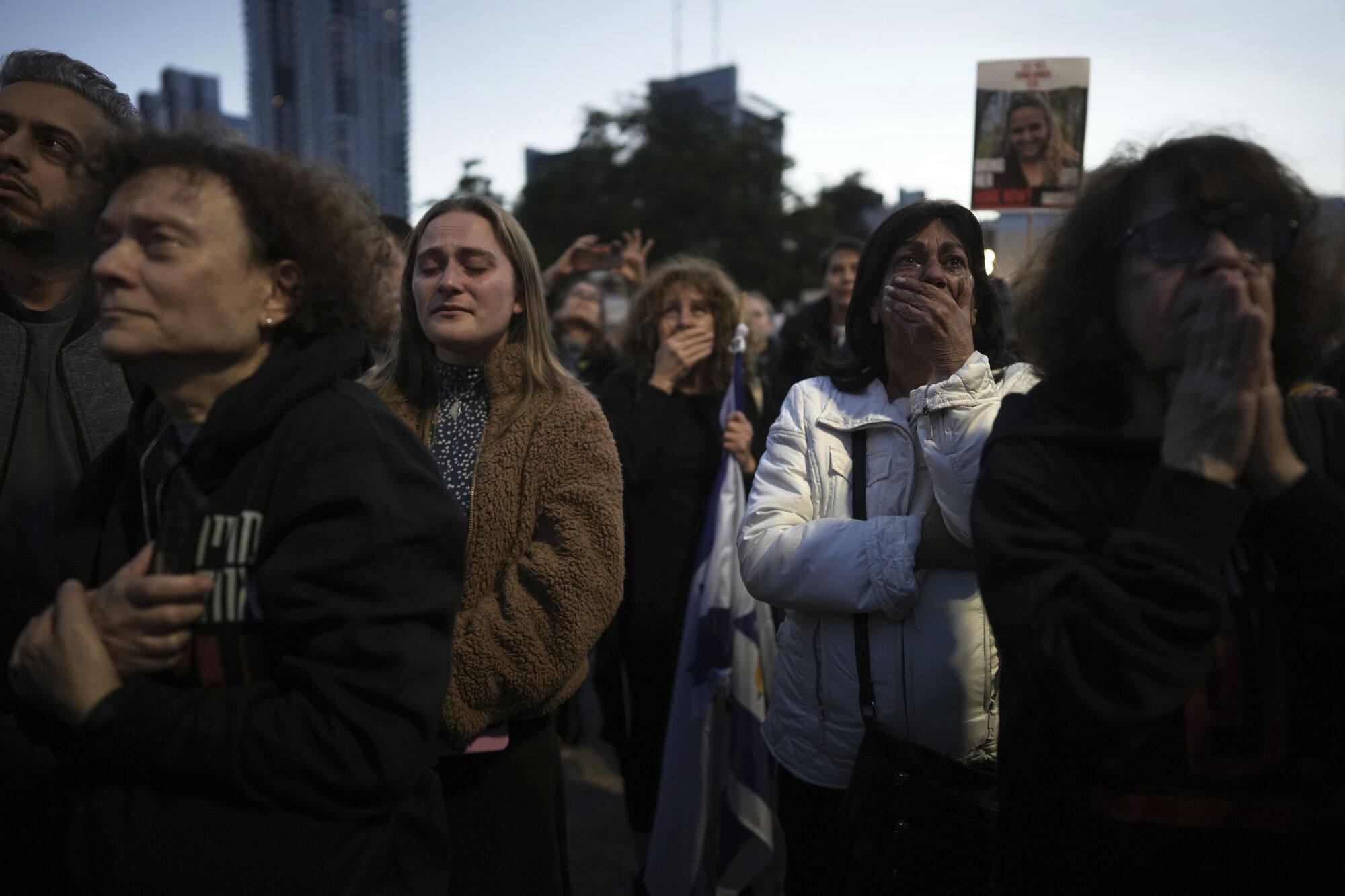 Relatives and friends of people killed and abducted by Hamas and taken into Gaza, react as they gather in Tel Aviv, Israel on Sunday, Jan. 19, 2025. (AP Photo/Oded Balilty). EDITORIAL USE ONLY / ONLY ITALY AND SPAIN