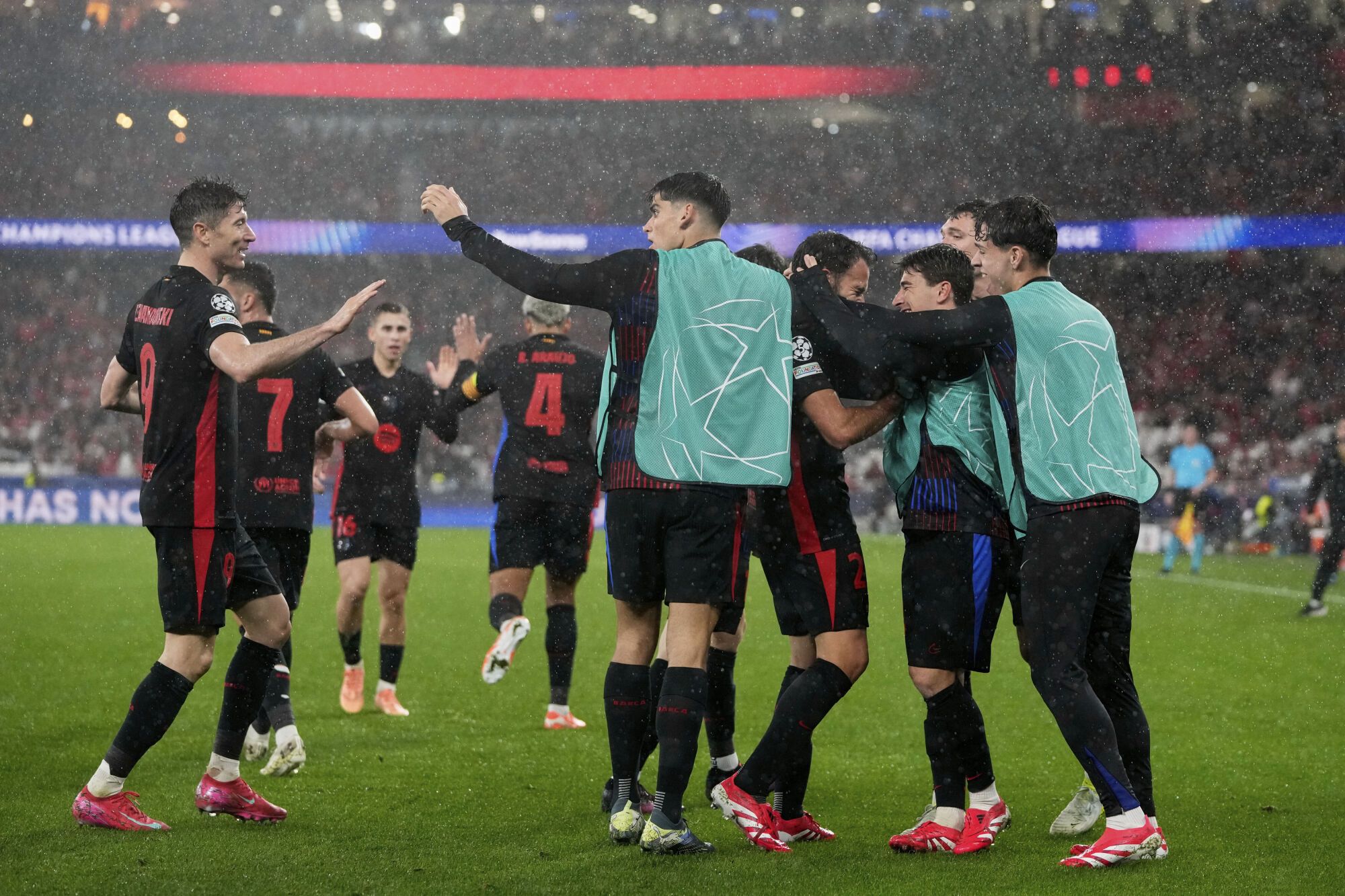 Barcelona celebrate their side's fourth goal during a Champions League opening phase soccer match between SL Benfica and FC Barcelona at the Luz stadium in Lisbon, Tuesday, Jan. 21, 2025. (AP Photo/Armando Franca)