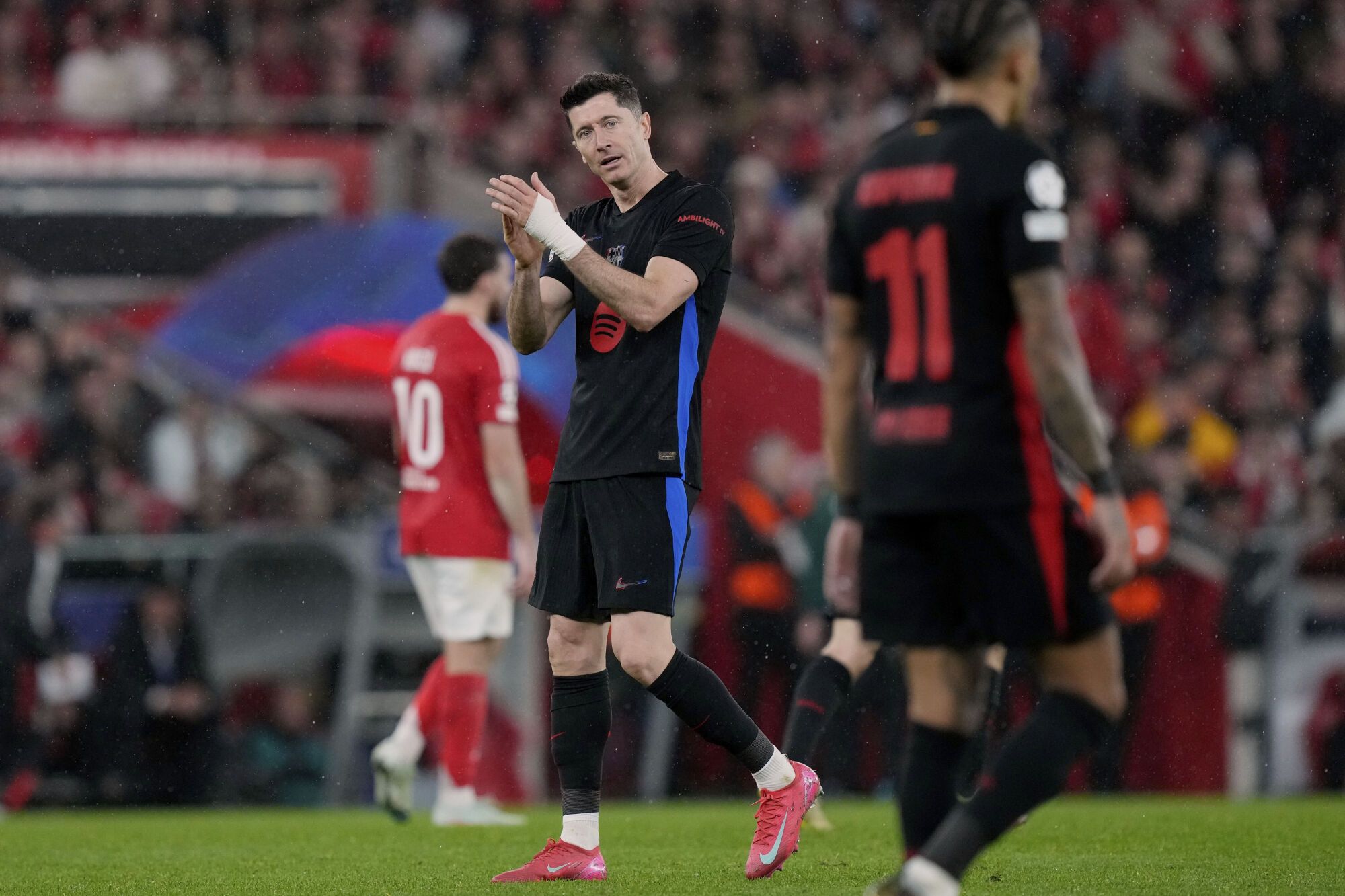 Barcelona's Robert Lewandowski reacts during a Champions League opening phase soccer match between SL Benfica and FC Barcelona at the Luz stadium in Lisbon, Tuesday, Jan. 21, 2025. (AP Photo/Armando Franca)