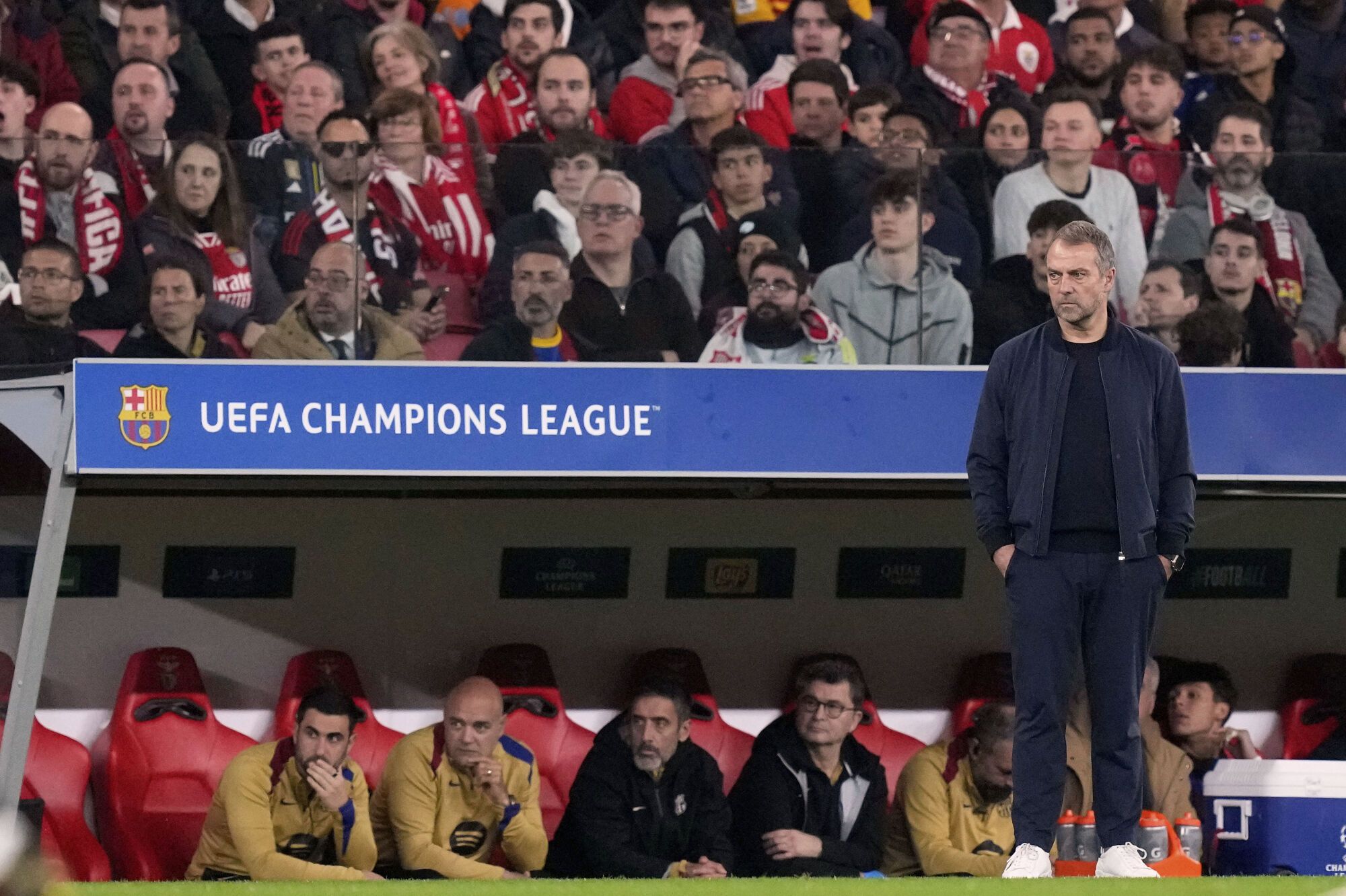 Barcelona's head coach Hansi Flick observes the play of his players during a Champions League opening phase soccer match between SL Benfica and FC Barcelona at the Luz stadium in Lisbon, Tuesday, Jan. 21, 2025. (AP Photo/Armando Franca)