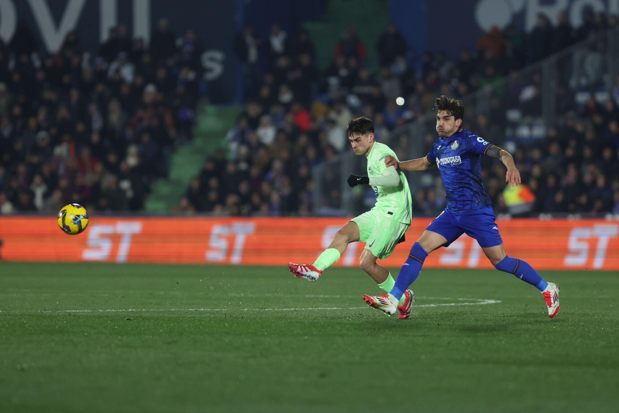 GETAFE (MADRID), 18/01/2025.- El centrocampista del FC Barcelona, ​​Pedri (i), golpea el balón contra el centrocampista uruguayo del Getafe, Mauro Arambarri, durante el partido correspondiente a la jornada 20 de Laliga EA Sports que se disputa hoy sábado Getafe y FC Barcelona en el Coliseo de Getafe. EFE/Kiko Huesca.