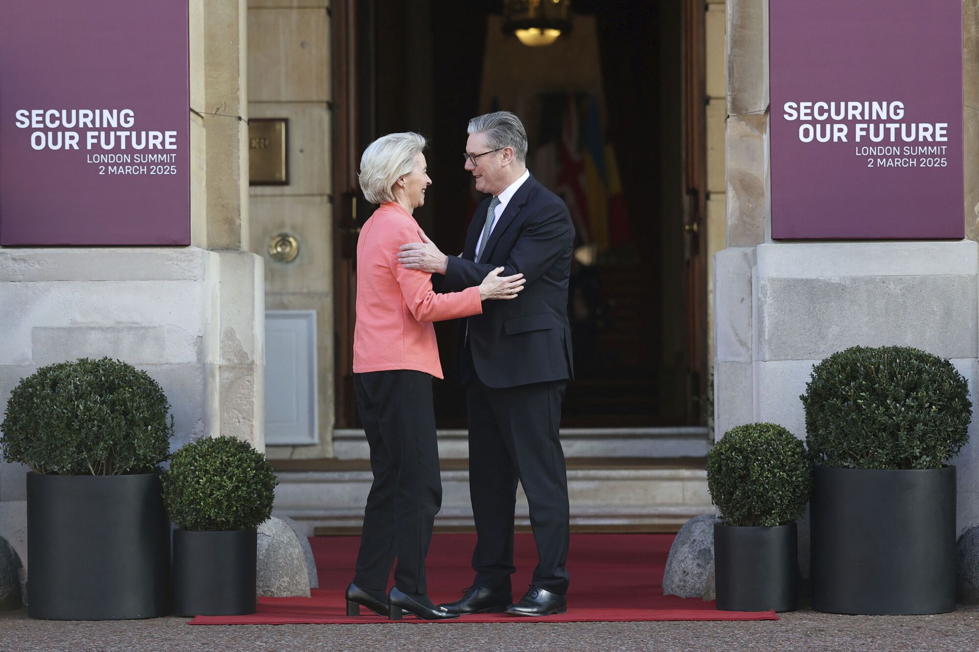 Britain's Prime Minister Keir Starmer, right, welcomes European Commission President Ursula von der Leyen to the European leaders' summit to discuss Ukraine, at Lancaster House, London, Sunday March 2, 2025. (Toby Melville/Pool via AP). EDITORIAL USE ONLY / ONLY ITALY AND SPAIN