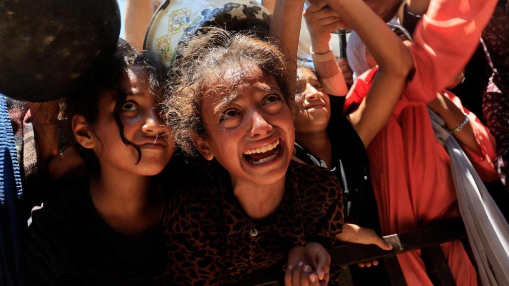 Niños palestinos que esperan recibir comida en plena crisis humanitaria en Gaza.