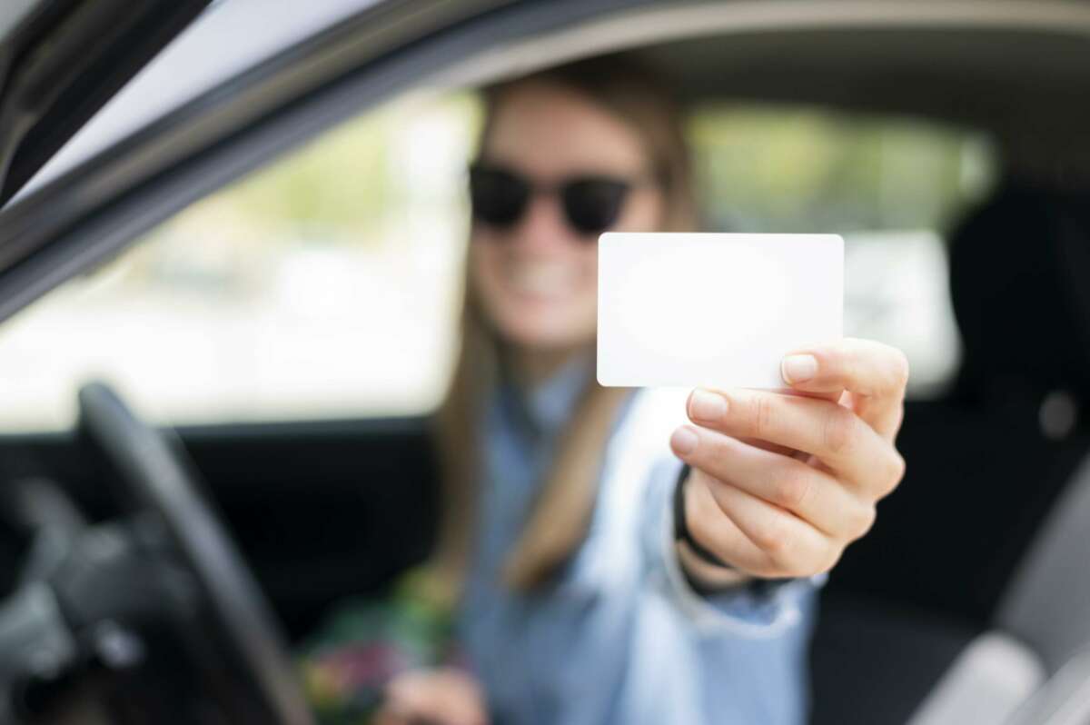 Una niña tiene su licencia de conducir.