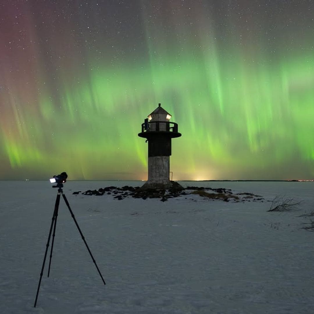 Faro bajo la aurora boreal en Oulu, Finlandia