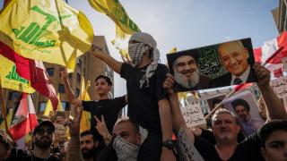 Protesters, including Hezbollah supporters, chant slogans during a protest against direct negotiations between Israel and Lebanon, in Beirut.